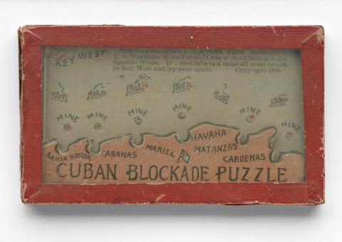 Small game picturing a map of Cuba, with ball bearings and indentations.