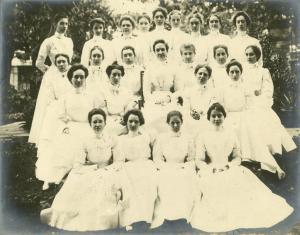 Group photo of army nurses dressed in white.