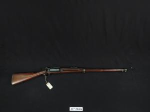 Rifle with a wooden stock and metal barrel.