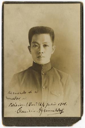 Photo of a young Asian man in a plain gray jacket. 