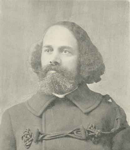 Book opened to the frontispiece showing a photographic portrait of a man with long hair and a beard.